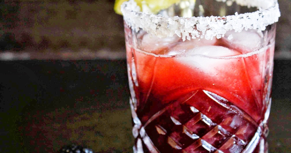 National Margarita Day Recipes Close Up of a Blackberry Margarita Garnished with Salt on the Rim and a Lime Wedge
