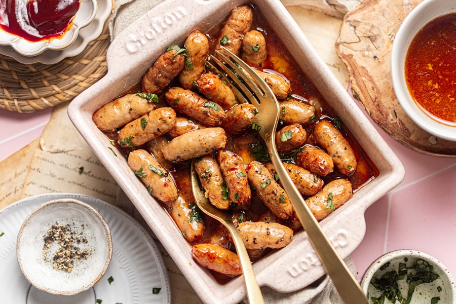 Easter Appetizers a Small Bowl Filled with Lil' Smokies and Two Forks