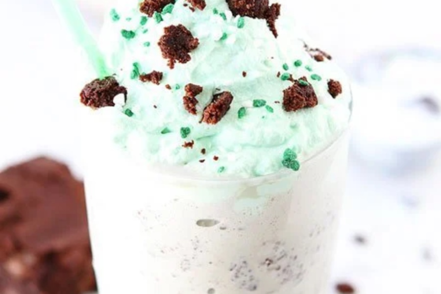 Green Drinks For Kids Close Up of a Mint Chocolate Chip Shake with Green Whipped Topping