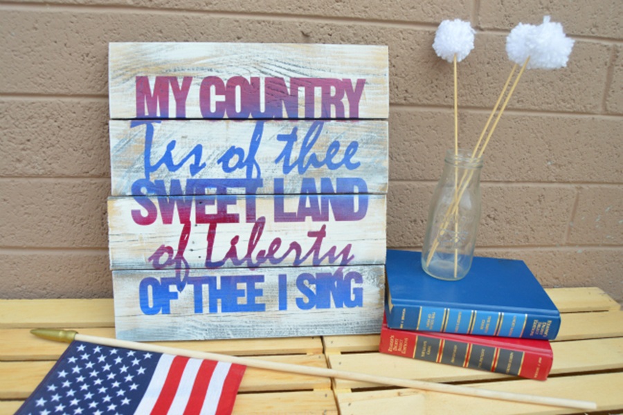 4th of July Party Ideas Patriotic Pallet Art Next to a Small American Flag