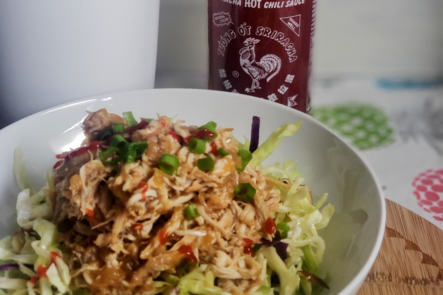Slow Cooker Hawaiian Chicken Close Up of Hawaiian CHicken Topped with Scallions and Drizzled with Hot Sauce
