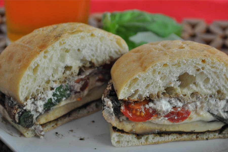 Portobello Mushroom Burger Cut in Half on a White Plate