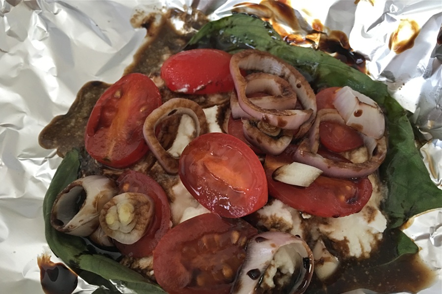 Portobello Mushroom Burger Topped with Cherry Tomatoes, Basil, and Ricotta Cheese