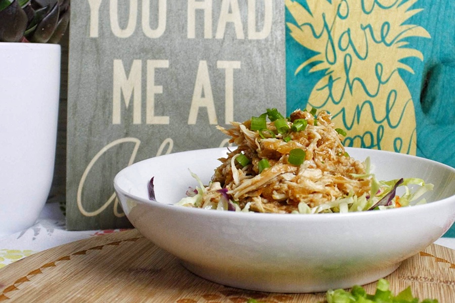 Slow Cooker Hawaiian Chicken a Bowl of Hawaiian Chicken in Front of Wooden Signs That Say You Had Me at Aloha