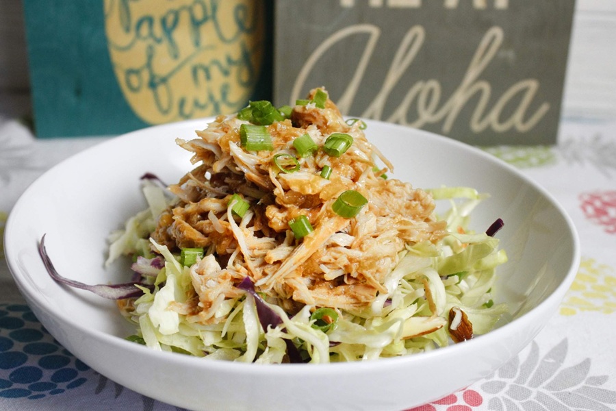 Slow Cooker Hawaiian Chicken a White Bowl of Hawaiian Chicken on Shredded Lettuce