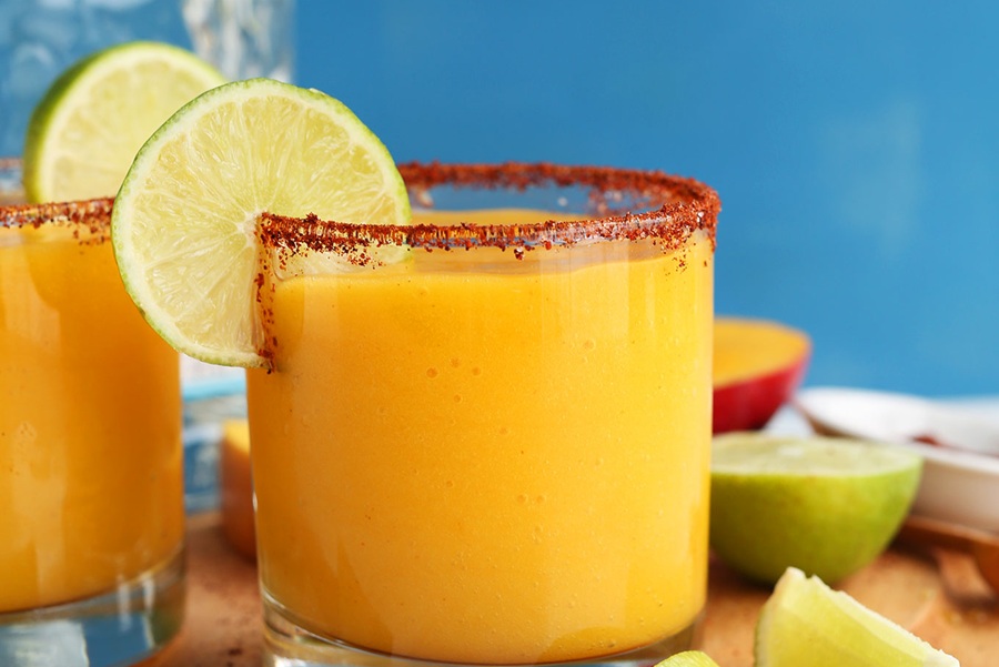 Summer Margarita Recipes Close Up of Chili Lime Mango Margaritas Garnished with a Lime Slice