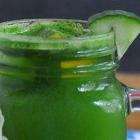 Jillian Michael&rsquo;s Green Juice Recipe in a Mason Jar Glass with a Cucumber Wedge Garnish