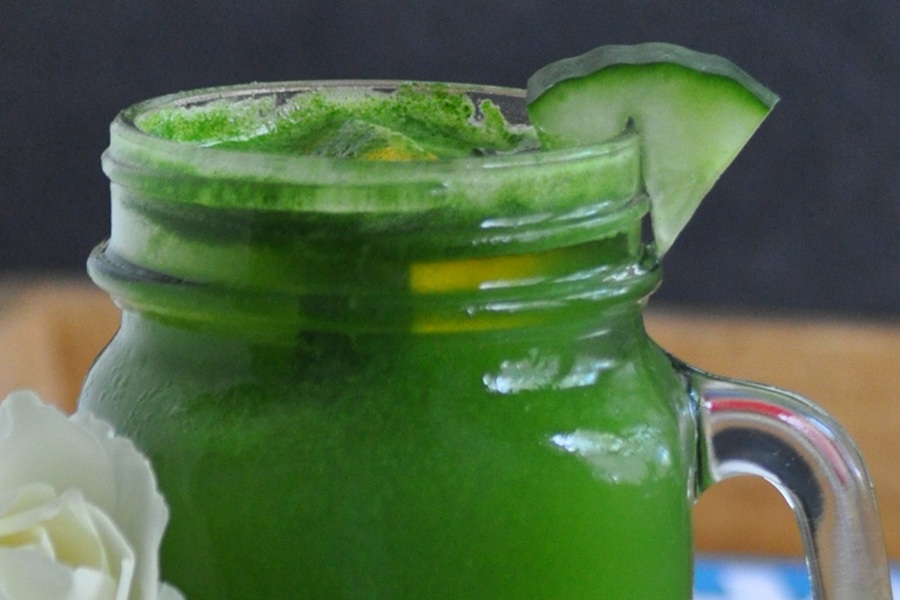 Jillian Michael&rsquo;s Green Juice Recipe in a Mason Jar Glass with a Cucumber Wedge Garnish