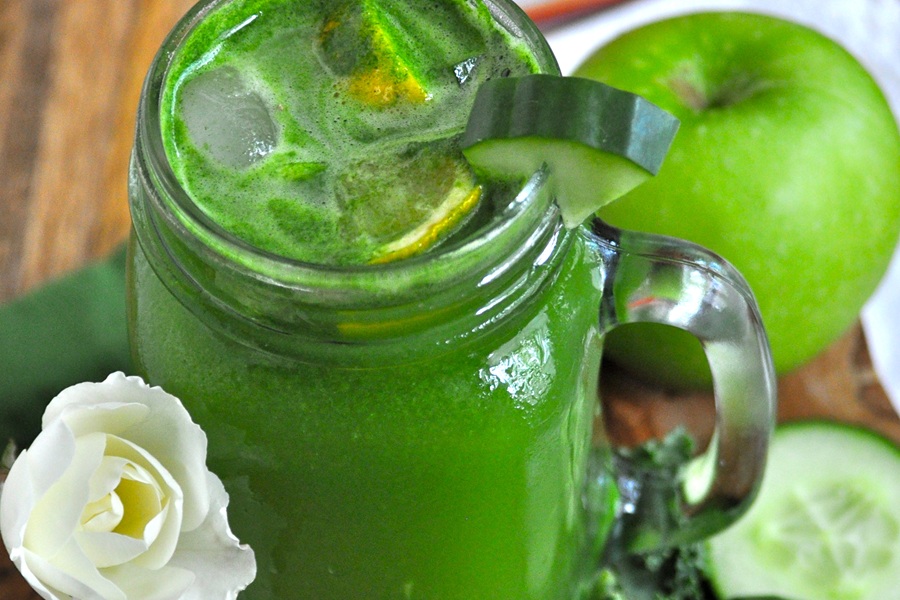 Jillian Michael&rsquo;s Green Juice Recipe in a Mason Jar Glass Garnished with a Cucumber Wedge and Lemon Slices