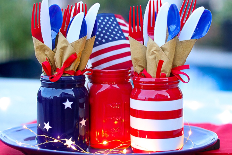 DIY Patriotic Decorations Patriotic Napkin Bundles in American Flag Colored Mason Jars on a Table Outside