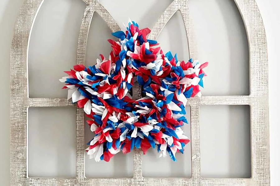 DIY Patriotic Decorations Fun Red, White and Blue Wreath Hanging on a White Door