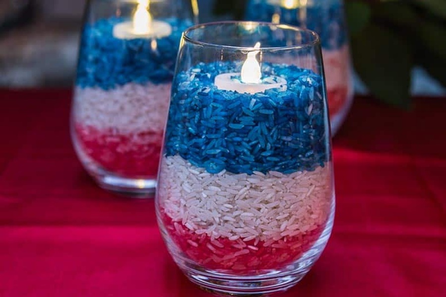 DIY Patriotic Decorations Three DIY Red, White, and Blue Rice Candle Holders Lit Candles in Each