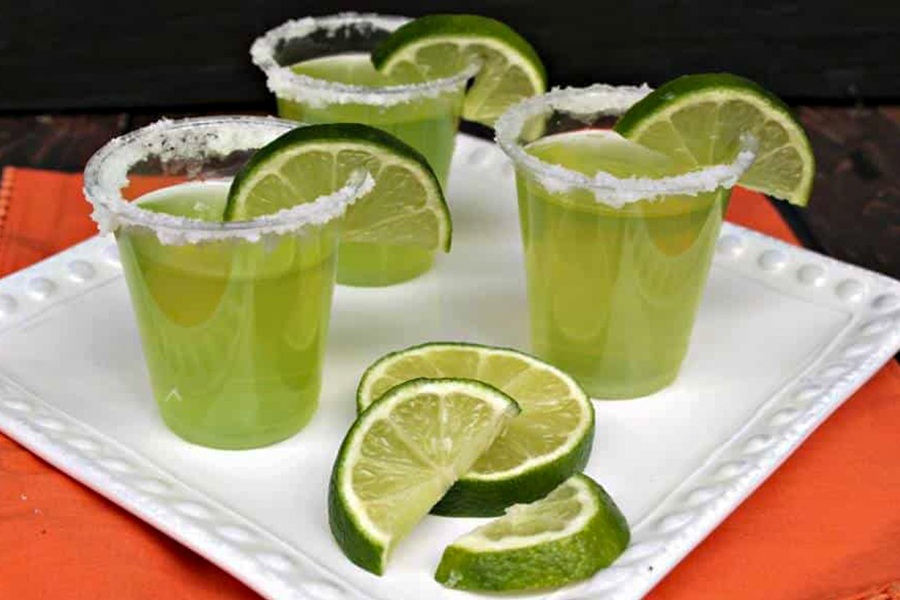 Easy Margarita Jello Shots Lime Margarita Jello Shots in Small Glasses on a White Plate