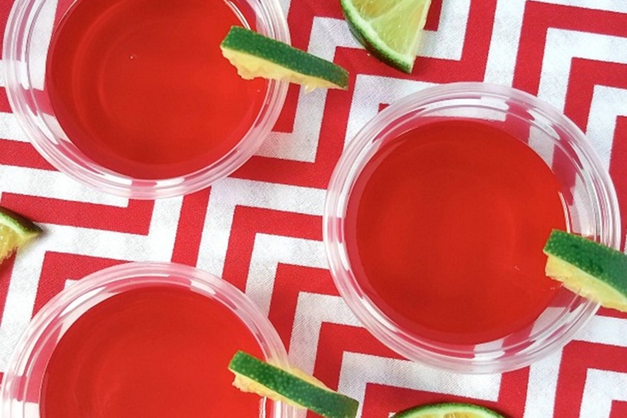 Easy Margarita Jello Shots Raspberry Margarita Jello Shots Garnished with Lime Wedges