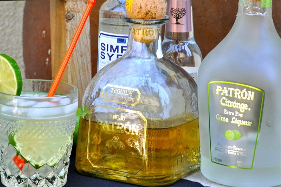 Low Carb Margarita Recipe Close Up of a Bottle of Patron with a Margarita in View