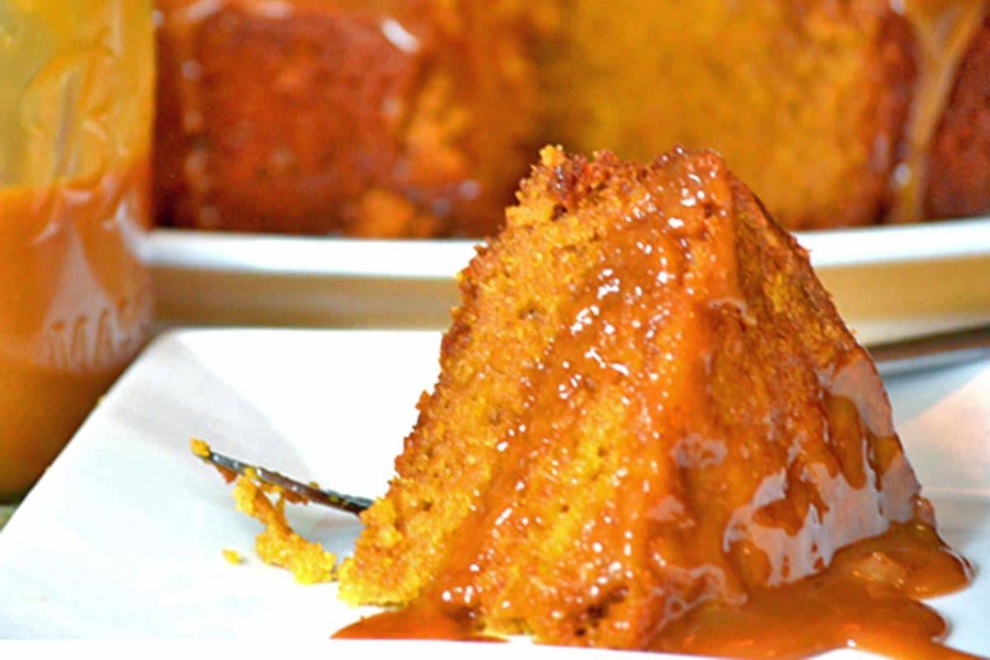 Crockpot Halloween Recipes a Slice of Pumpkin Cake on a White Plate