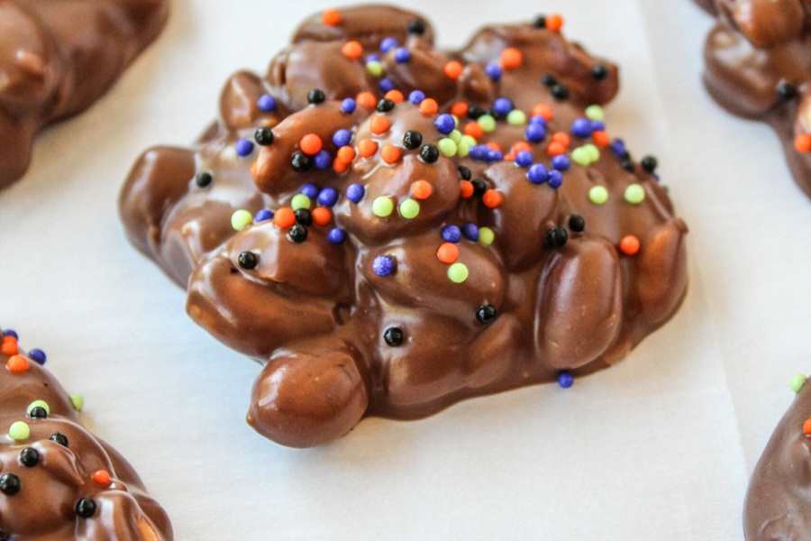 Crockpot Halloween Recipes Chocolate Candies Covered in Purple, Green, Orange, and Black Sprinkles