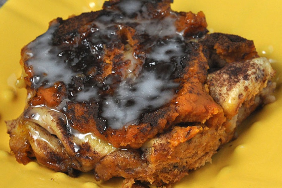 Crockpot Halloween Recipes Close Up of Pumpkin Cinnamon Rolls on a Yellow Plate