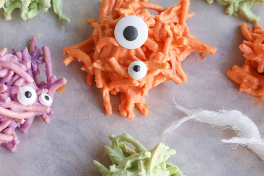 Spooky Halloween Crockpot Recipes Small Clusters of Candy with Candy Eye Balls On Top of Each Little Mound