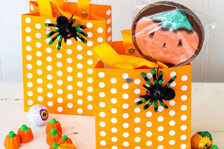 You&rsquo;ve Been BOOed Two Orange Treat Bags Filled with Halloween Treats on an Orange Surface